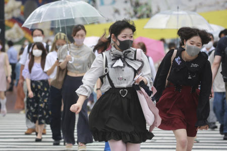People wearing face masks to protect against the spread of the coronavirus in Tokyo on Tuesday, Aug. 17, 2021. (AP)