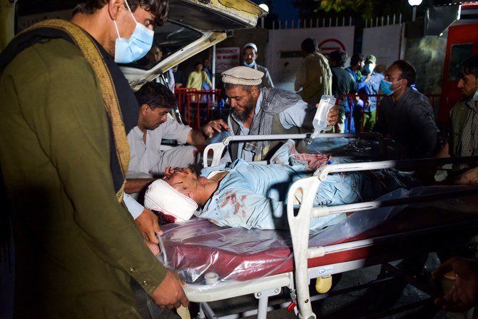 A man injured in the explosions at Kabul airport is brought into hospital for treatment. (AFP)