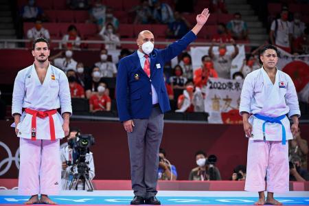 Japan's Ryo Kiyuna is awarded the gold medal over Spain's Damian Quintero (left) after the men's kata final bout of the karate competition during the Tokyo 2020 Olympic Games at the Nippon Budokan in Tokyo on August 6, 2021. (AFP)