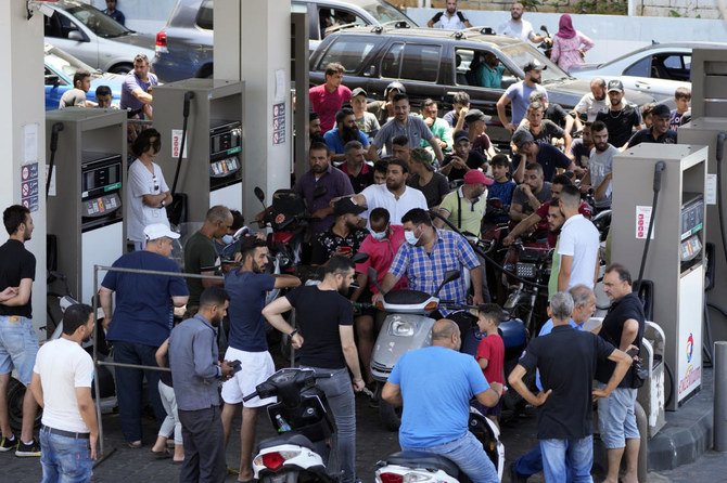 Motorcycle drivers wait to get fuel at a gas station in Beirut. A brawl at a gas station in northern Lebanon over scarce fuel supplies descended into deadly violence on Monday. (AP)