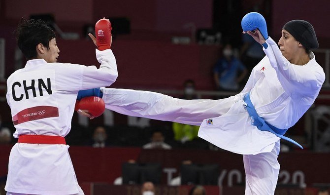 China's Yin Xiaoyan (L) competes against Egypt's Giana Lotfy in the women's kumite -61kg semi-final of the karate competition during the Tokyo 2020 Olympic Games at the Nippon Budokan in Tokyo on August 6, 2021. (AFP)