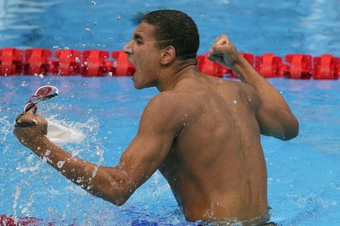 Ahmed Hafnaoui, of Tunisia, celebrates after winning the final of the men's 400-meter freestyle at the 2020 Summer Olympics, Sunday, July 25, 2021, in Tokyo, Japan. (AP)