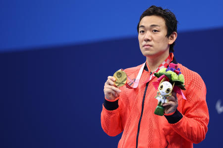 Gold medalist Naohide Yamaguchi of Japan celebrates on the podium. (Reuters)