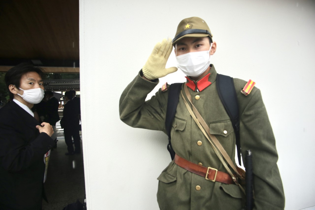 Some Japanese nationalists dressed in Imperial Army uniforms sported masks with Japan's Rising and Radiant Sun flag, an ancient symbol of the Imperial Army. (ANJP)