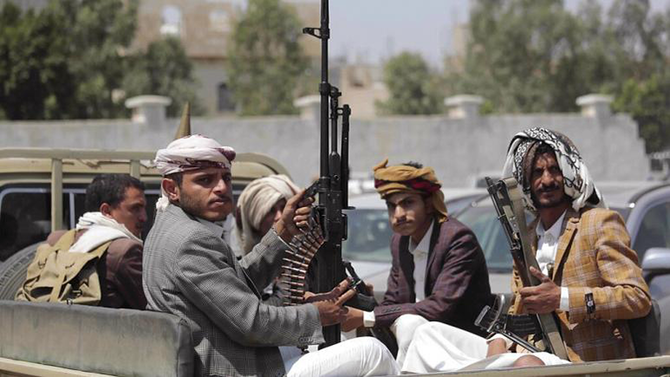 In this file photo, tribesmen loyal to Houthi rebels hold their weapons as they ride in a vehicle. (AP)