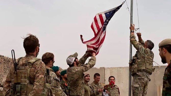 A U.S. flag is lowered at Camp Antonik, in Helmand province, southern Afghanistan, May 2, 2021. (AP Photo)