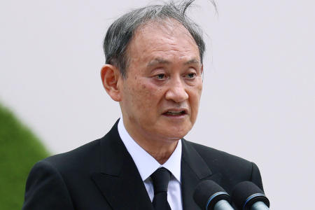 Japan's Prime Minister Yoshihide Suga delivers a speech during a ceremony at Nagasaki Peace Park in Nagasaki, southern Japan Monday, Aug. 9, 2021. (Kyodo News via AP)