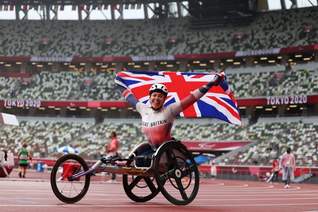 The Paralympic flag (L) is raised next to Japan's during the opening ceremony for the Tokyo 2020 Paralymapic Games at the Olympic Stadium in Tokyo, Aug. 24, 2021. (AFP)