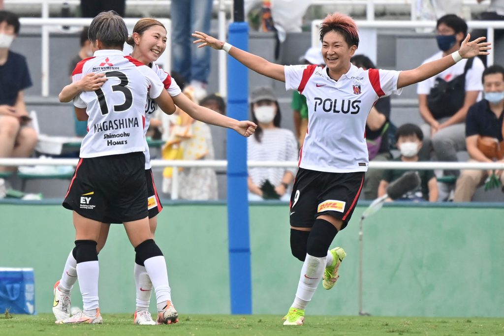 Urawa Reds Ladies' midfielder Yuzuho Shiokoshi (2nd L) celebrates her goal with teammates during the WE League football match between Tokyo Verdy Beleza and Urawa Reds Ladies in Tokyo on September 12, 2021. (Photo by Kazuhiro NOGI / AFP)