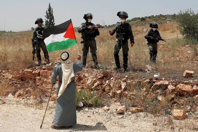 A Palestinian protests Israel’s plan to annex parts of the occupied West Bank, near Tulkarm, June 5, 2020. (Reuters)