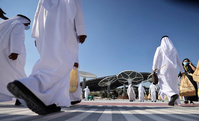 People walk towards the Sustainability Pavilion, a week ahead of its public opening, at the Dubai Expo 2020 in Dubai on January 16, 2021. (AFP)