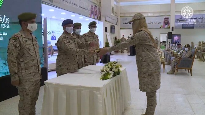 A graduate receives her certificate of completion of the basic military training. (Screengrab from Ministry of Defense video)