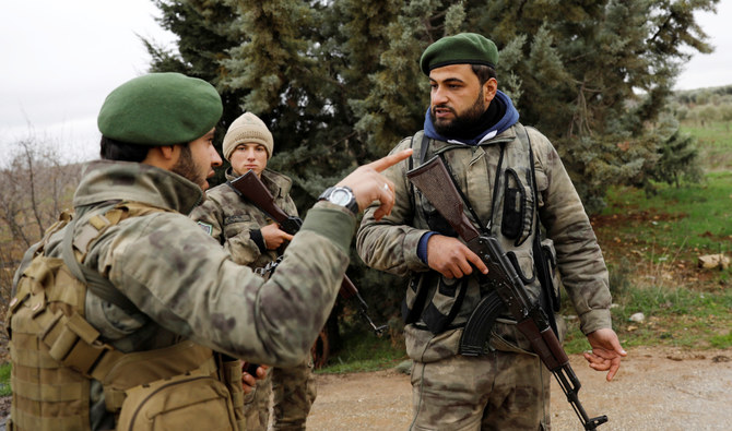 Members of Turkey-backed Free Syrian Army police forces secure the road as they escort a convoy near Azaz, Syria. (REUTERS file photo)