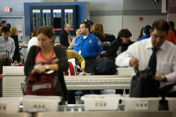 Passengers place their belongings in bins before passing through the passenger security checkpoint at John F. Kennedy International Airport's Terminal 8 on October 22, 2010. (File/AFP)