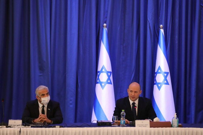 Israeli Prime Minister Naftali Bennett (R) and Foreign Minister Yair Lapid (L) attend a cabinet meeting at the Ministry of foreign affairs offices in Jerusalem, September 12, 2021. (Reuters)