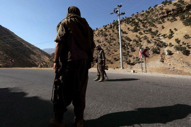 Turkey’s operation in Iraq targets the Kurdistan Workers Party (PKK), which has bases there. Above, PKK fighters on patrol in northwestern Idlib province. (AFP)