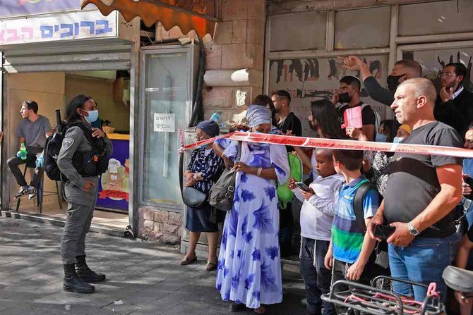 Israeli police officers gather outside the site of a stabbing attack, in Jerusalem on September 13, 2021. (AFP)