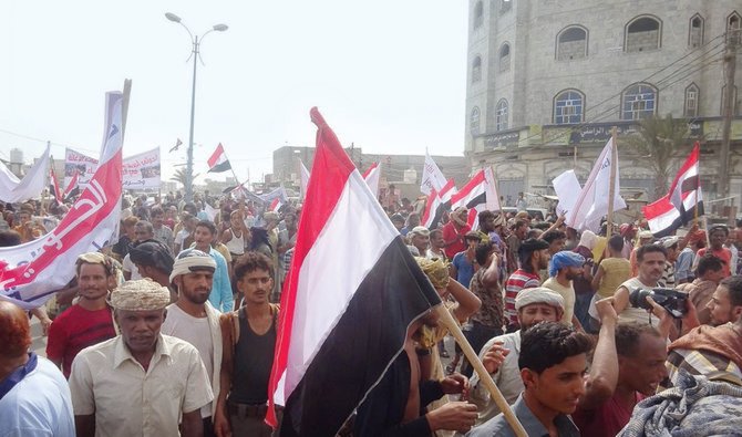 Carrying flags and posters, residents in Mocha marched through the streets to denounce the Houthi shelling which has brought port operations to a standstill. (Supplied)
