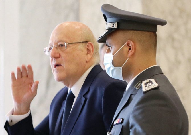 Lebanon’s Prime Minister Najib Mikati gestures as he leaves a ministerial council meeting at the Grand Serail (Government Palace) in the capital Beirut. (AFP)