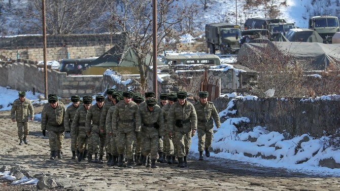 Azeri soldiers walk near their military vehicles in the Kalbajar district, Azerbaijan, Dec. 21, 2020. (Reuters)