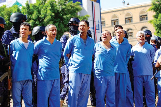 Six of the nine civilians convicted of involvement in a Houthi leader’s killing in 2018 are lined up before their public execution in Sanaa on Sept. 18, 2021. (AFP)