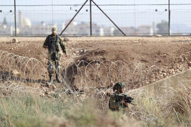 In this Sept. 12, 2021, file photo, Israeli soldiers take positions between the northern West Bank near Jenin and Israel in search of two Palestinians who broke out of a maximum-security. AP file photo)