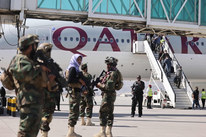 Fighters of the Taliban Badri 313 military unit stand guard as passengers on board a Qatar Airways aircraft disembark at the airport in Kabul on Sept. 14. (AFP/File Photo)