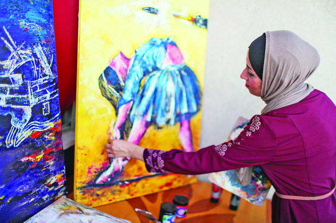 Jebril’s paintings show ‘what the woman feels, lives, faces and how she is chained,’ the artist says. (Reuters)