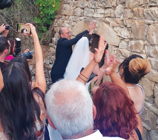 The couple perform a traditional ritual in the ruins of the home of the groom’s grandparents in Biram. (Supplied)