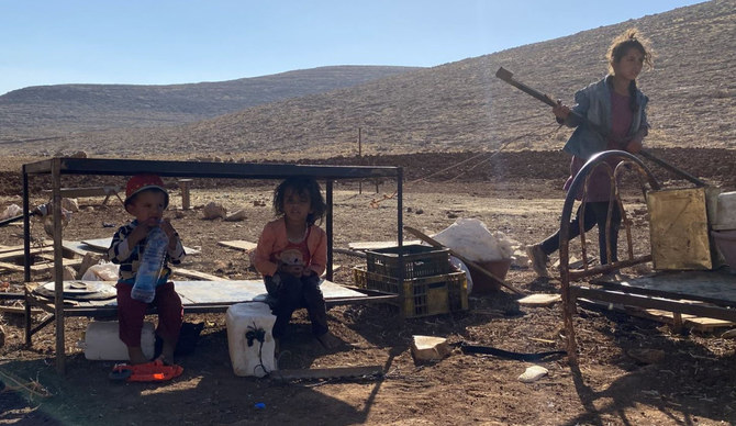 Children watch over what remained of their family belongings after Israeli authorities dismantled at least 49 structures in the Bedouin community of Ras Al-Tin in Ramallah on July 14. (Twitter/@ochaopt)