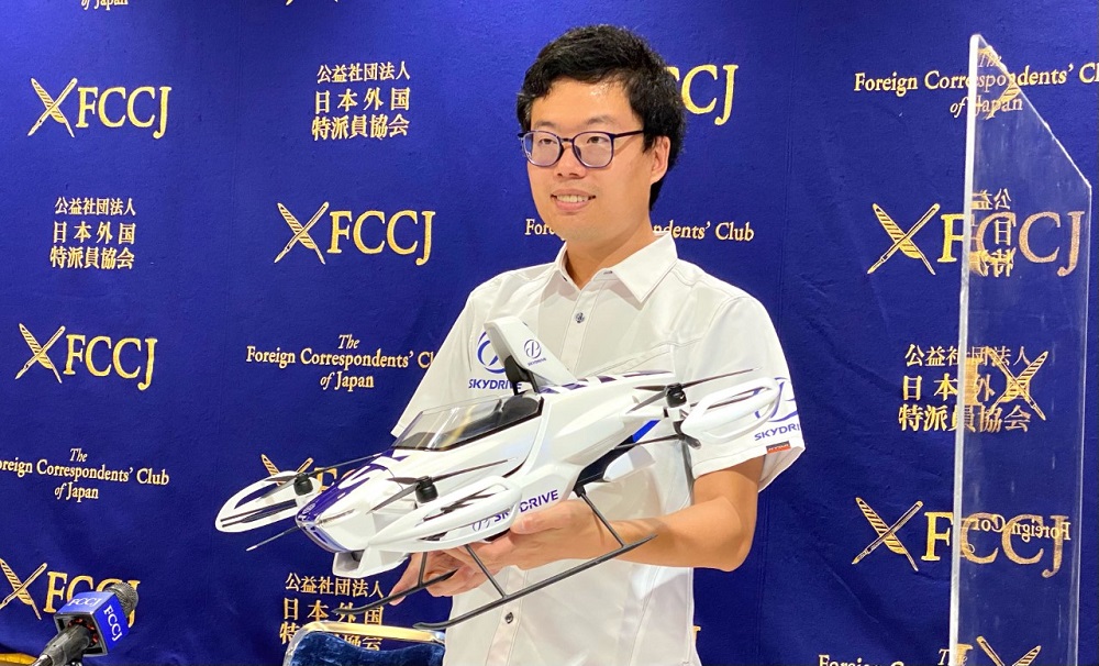 Tomohiro Fukuzawa, CEO of SkyDrive, holds a prototype of future drone sky taxi at a press conference in Tokyo (ANJ)