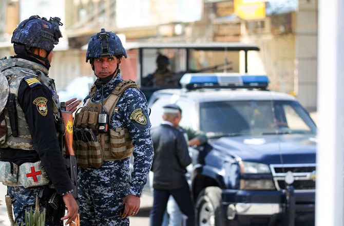 Members of the Iraqi federal police forces stand guard at a checkpoint in a street in the capital Baghdad. (File/AFP)
