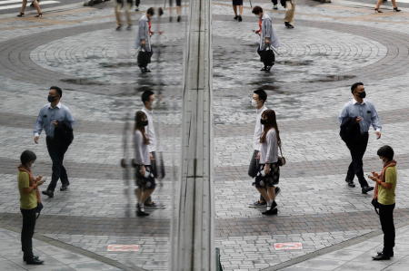 People wearing protective masks, amid the coronavirus disease (COVID-19) outbreak, make their way at a shopping district in Tokyo, Japan, September 9, 2021. (Reuters)