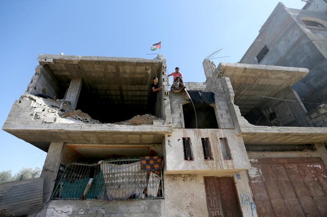 Palestinians work in their house that was destroyed by Israeli strikes during Israel-Hamas fighting last May, in Khan Younis in southern Gaza Strip September 26, 2021. (Reuters)