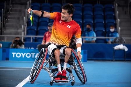 Japan's Shingo Kunieda hits a return against Netherlands' Tom Egberink during their men's singles gold medal wheelchair tennis match at the Tokyo 2020 Paralympic Games at Ariake Tennis Park in Tokyo on September 4, 2021. (AFP)