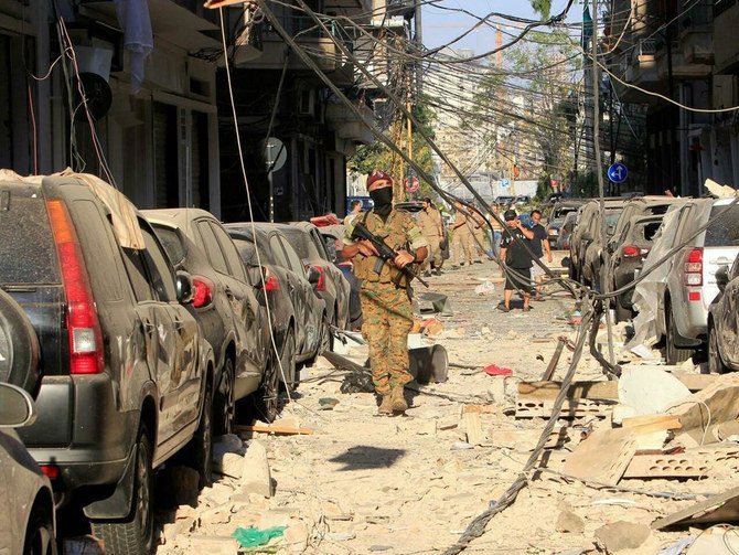 A member of the Lebanese security forces surveys the damage following an explosion at Beirut Port, Lebanon, August 5, 2020. (Reuters)