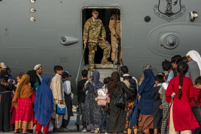 US Air Force Service members prepare to board evacuees onto a C-17 Globemaster lll on Aug. 22, 2021, at Al Udeid Air Base, Qatar. (File/AFP)