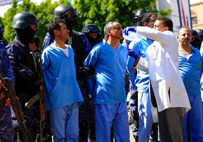 A medic gives a defendant water before being executed after being convicted with eight others of involvement in the assassination of Houthi political leader Saleh Al-Samad three years ago. (AFP)