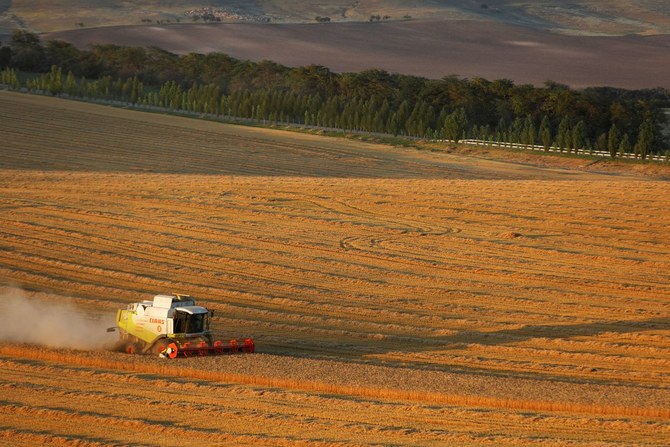 A combine harvests wheat in a field near the village of Suvorovskaya in Stavropol Region, Russia, July 17, 2021. (Reuters)