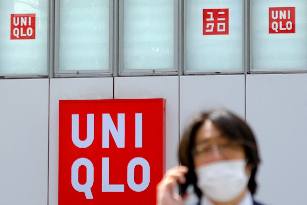 A pedestrian walks past a Uniqlo clothing store operated by Japan's Fast Retailing in Tokyo on April 8, 2021. (AFP)