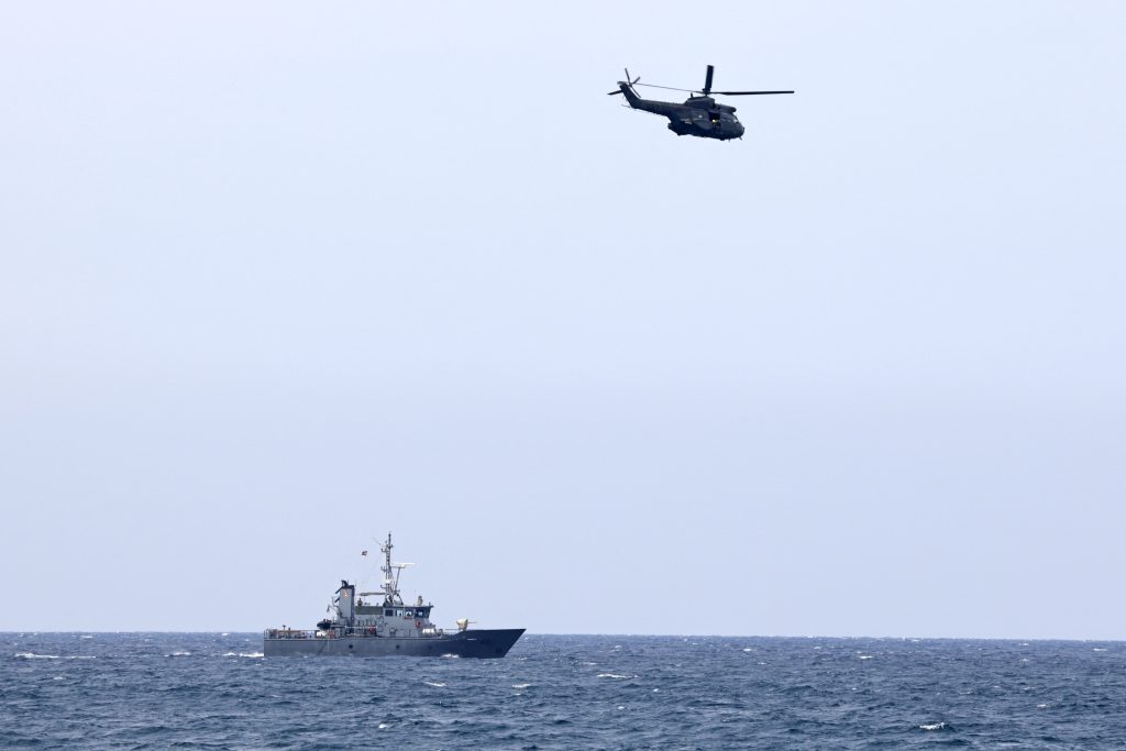 Lebanese coast and rescue personnel conduct a search operation after a small training aircraft crashed off the coast of Halat town, north of the capital Beirut, on October 13, 2021. (AFP)
