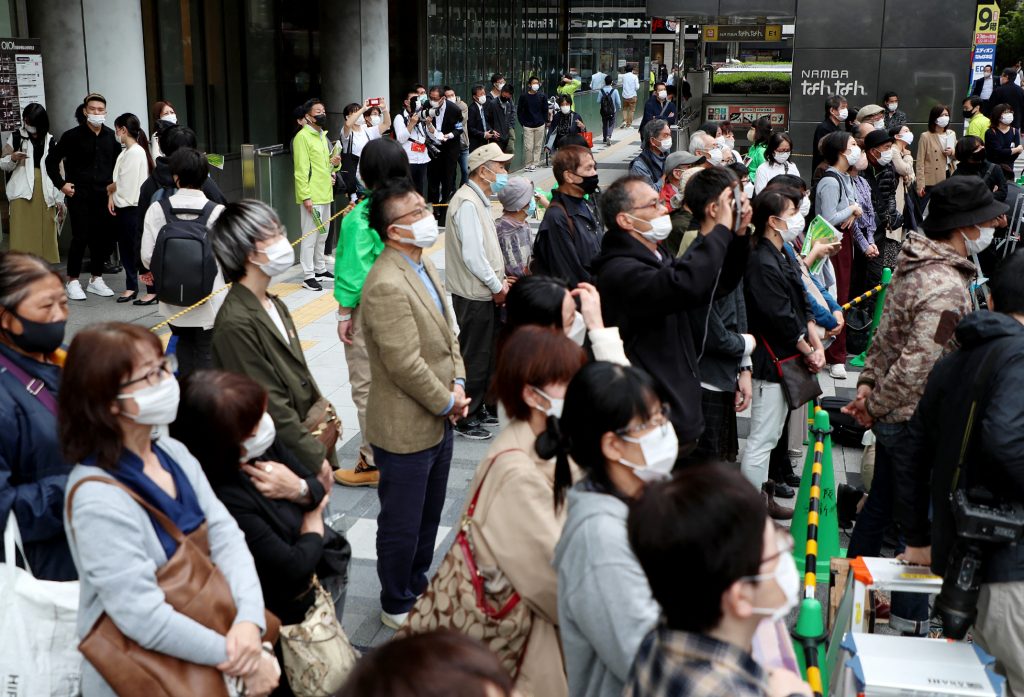 People listen to a politician's speech during an election campaign in Osaka on October 19, 2021 on the first day of campaigning for the Japan's upcoming general election. (AFP)