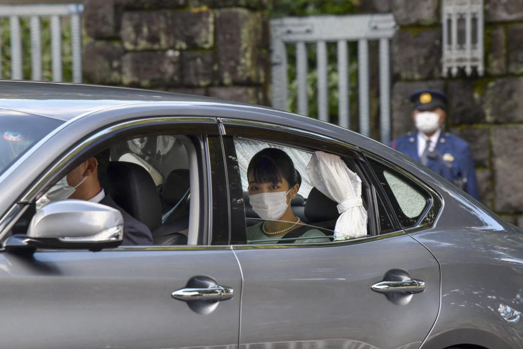 Japan's Princess Mako (C) leaves Akasaka Estate in Tokyo on October 26, 2021, to attend a press conference with her husband Kei Komuro. (AFP)