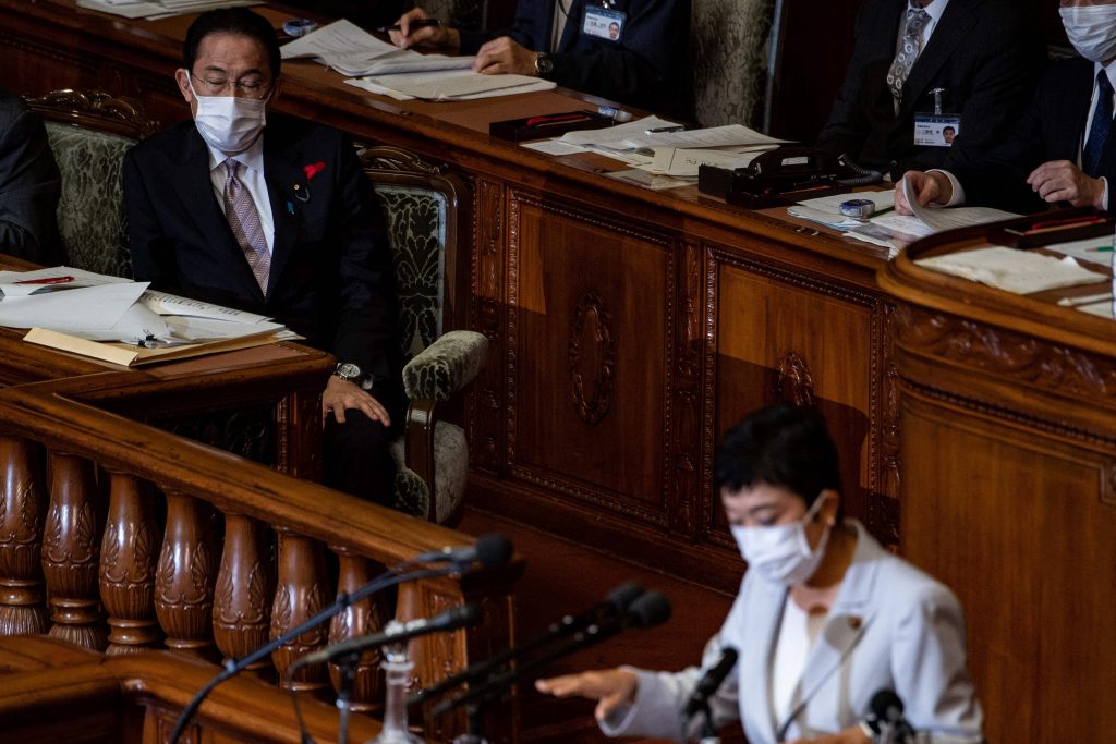 Japan's Prime Minister Fumio Kishida (L) listens to lawmaker Kiyomi Tsujimoto (R) during a question and answer session at the lower house of parliament in Tokyo, Oct. 11, 2021. (AFP)