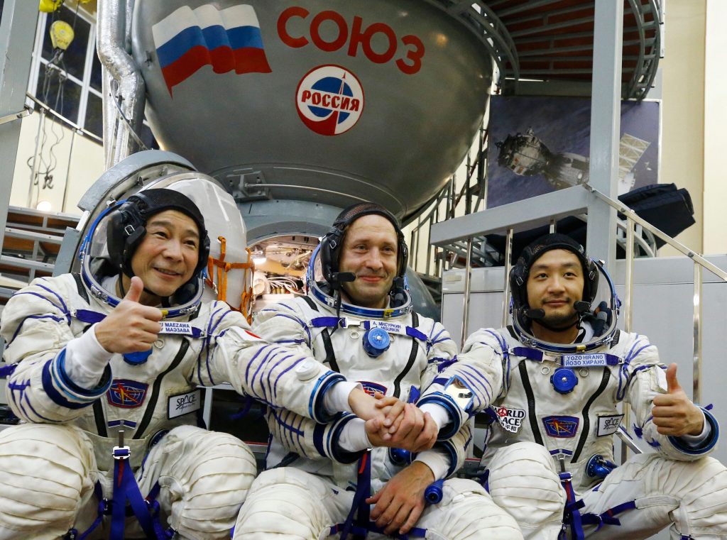 Roscosmos cosmonaut Alexander Misurkin (center), and space flight participants Yusaku Maezawa (left) and Yozo Hirano pose for a picture during a training session. (AP)