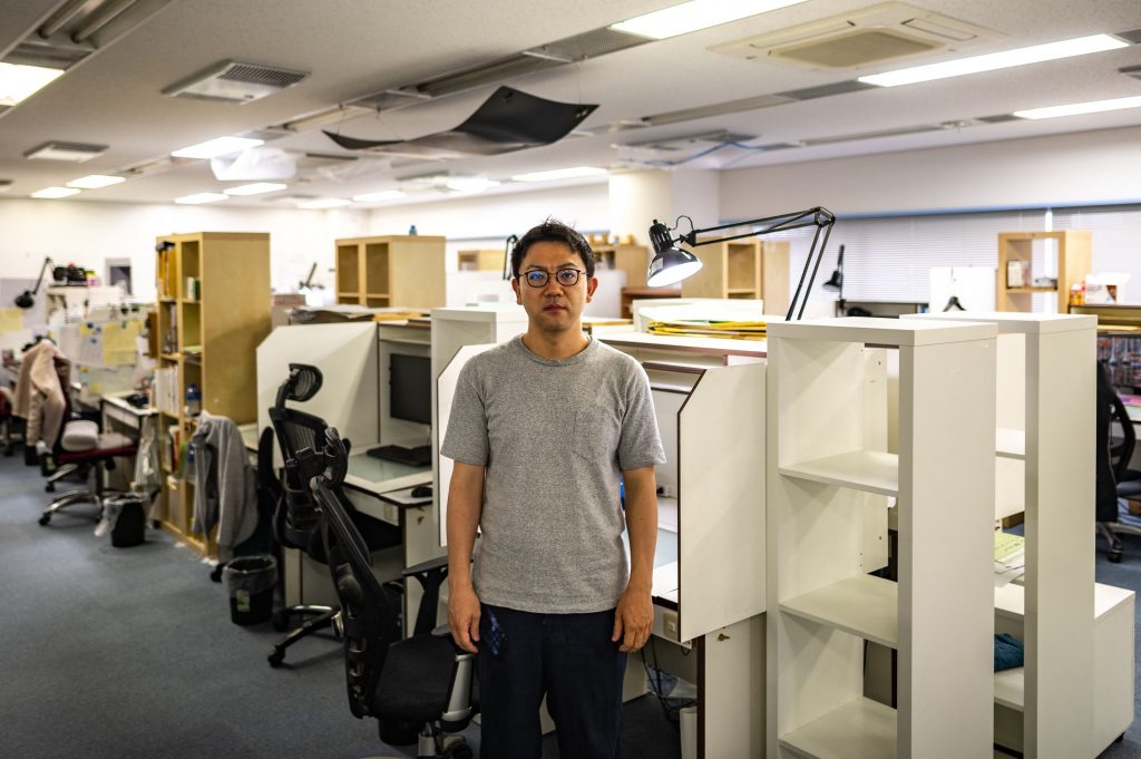 This picture taken on July 6, 2021 shows George Wada, CEO of anime school Wit studio, posing in his studio following an interview with AFP in Tokyo. Japan is facing a shortage of skilled animators, in part because most face years toiling in low-paying jobs to learn the ropes, meaning much of the painstaking frame-by-frame drawing work is outsourced overseas. (AFP)