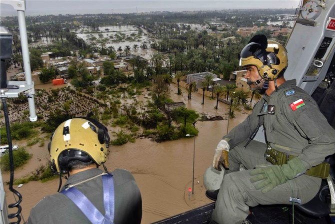 In this photo released by the Oman News Agency, Oman Air Force personnel fly over the Al Khaburah district to assess damage from Cyclone Shaheen, in Oman, Monday, Oct. 4, 2021. (AP)