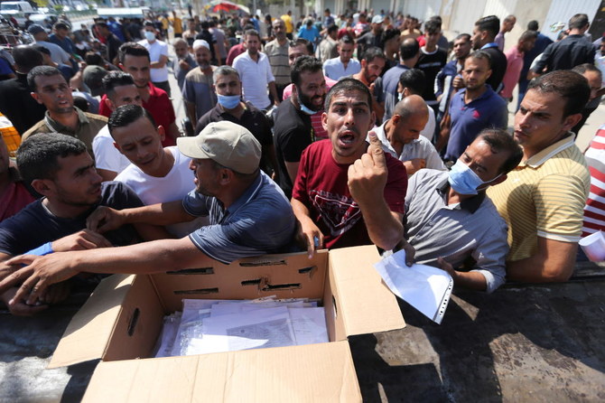 Palestinians gather to apply for Israeli work permits, in Khan Younis, in southern Gaza Strip on Wednesday. (Reuters)