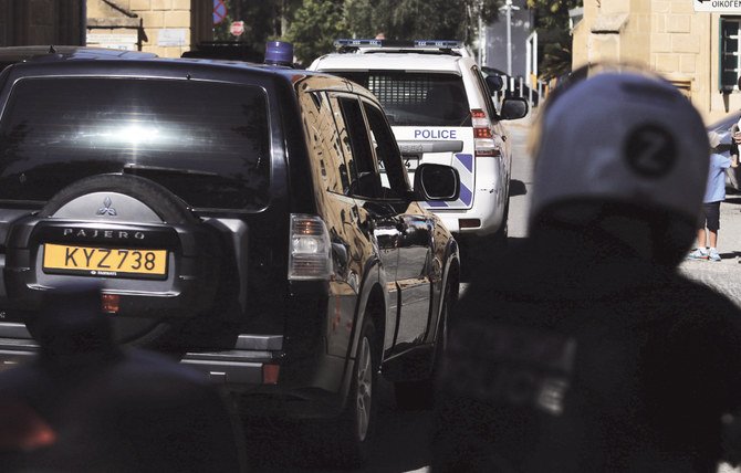 A convoy of police vehicles arrive at a court where a remand order was issued against an ethnic Azeri with a Russian passport. (Reuters)