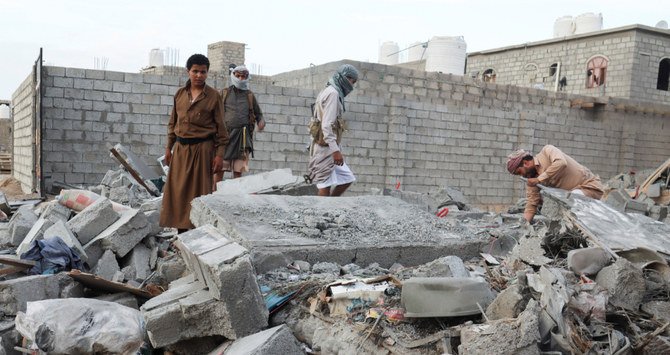 People browse through the rubble of a house destroyed by Houthi missile attack in Marib, Yemen. (Reuters)
